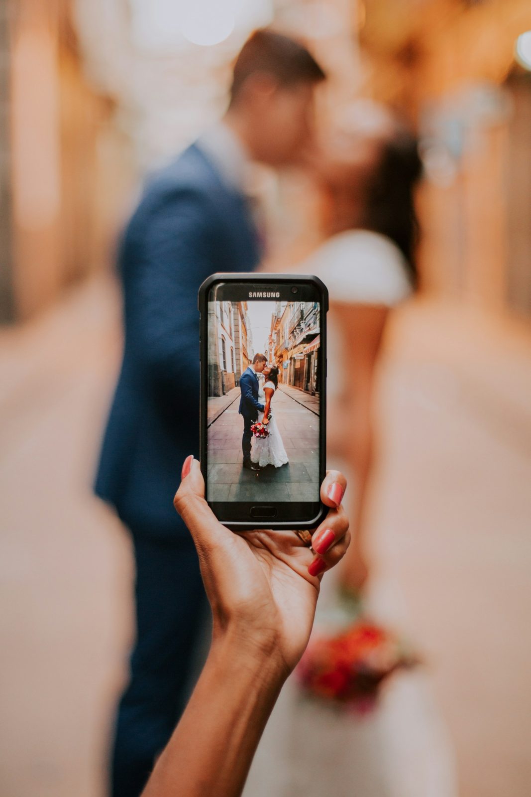 A guest taking a photo of the happy couple