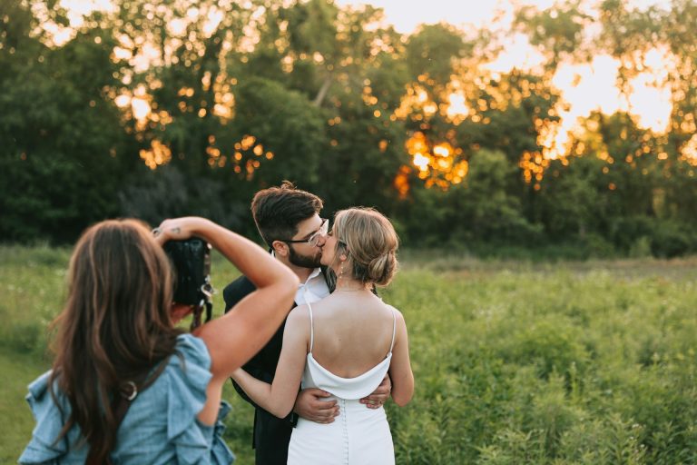 Wedding photographer taking a couple shot outside
